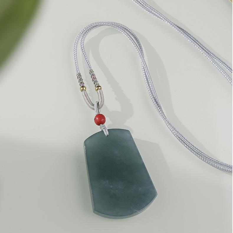 Tibetan Buddhist blue jade talisman symbolizing peace, wisdom, and positive energy.