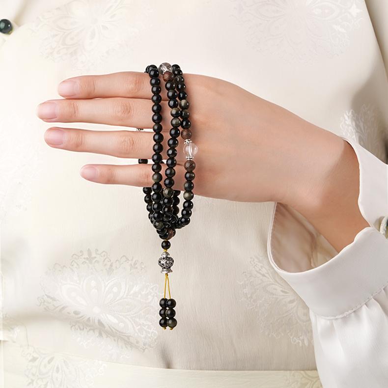 Golden obsidian Tibetan mala inspired by night star patterns, handmade with natural wood and crystal beads.