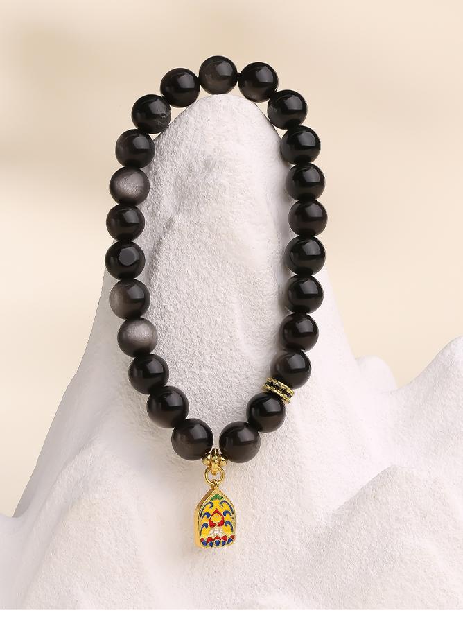 Xinghai Tibetan-Buddhist Obsidian Bracelet with elastic cord, handmade bead craftsmanship, and ocean-night inspired design.