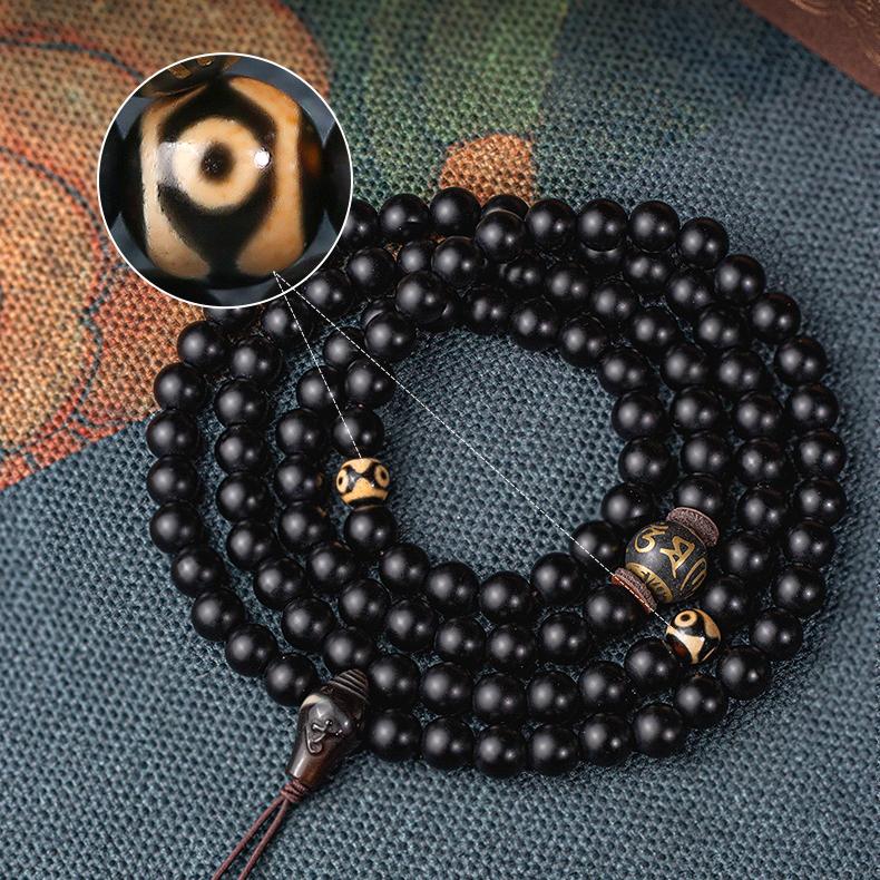 Tibetan Buddhist handmade obsidian mala featuring 108 beads, three-eye dzi bead, and agate three-way connector.