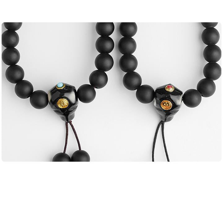 Black obsidian Tibetan mala with 108 polished beads and artisan-made agate three-way connector.