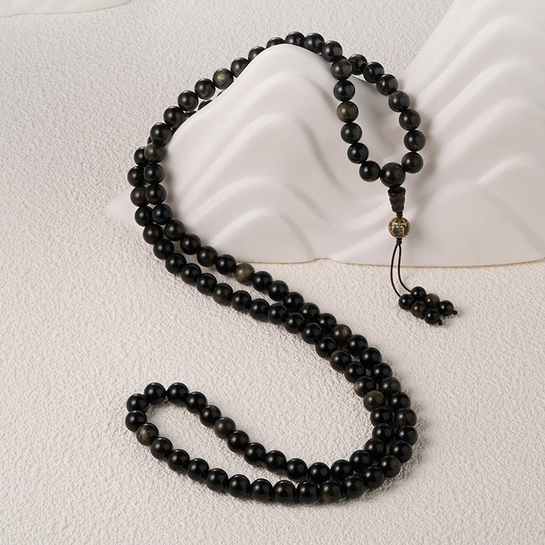 Golden obsidian meditation necklace inspired by Tibetan Buddhist jewelry culture.