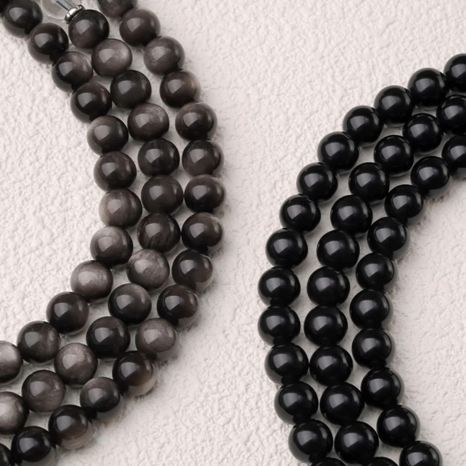 Tibetan Buddhist black obsidian mala necklace featuring tiger eye beads and silver three way element