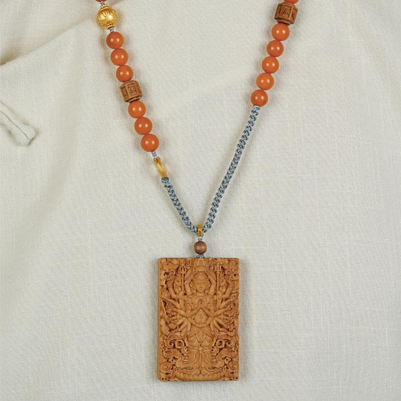 Old sandalwood necklace featuring a hand-carved lotus pendant, symbolizing purity and enlightenment.
