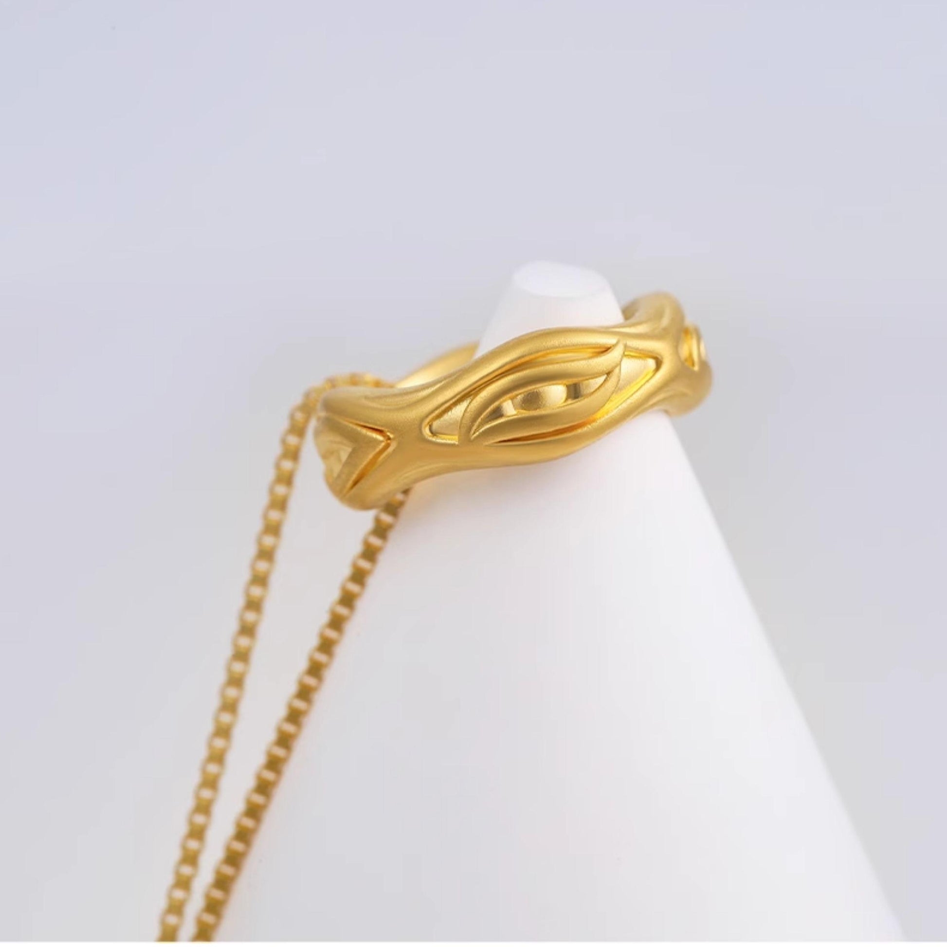 Gold and silver Tibetan necklace designed as a sacred eye symbol of compassion and insight.