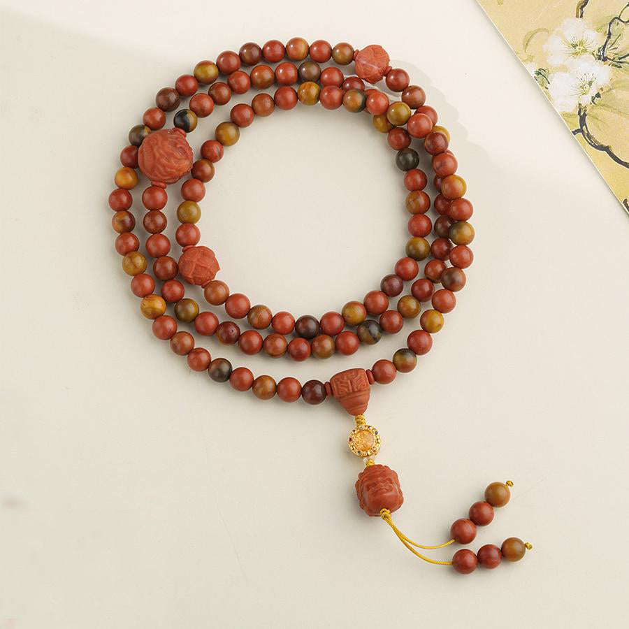 Tibetan Buddhist 108 red agate beads with silver accents, perfect for meditation and blessings.