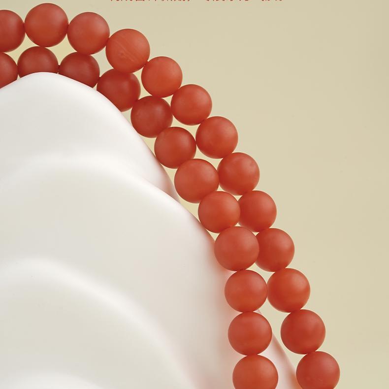 Red agate and silver mala combining Tibetan artistry and healing symbolism.