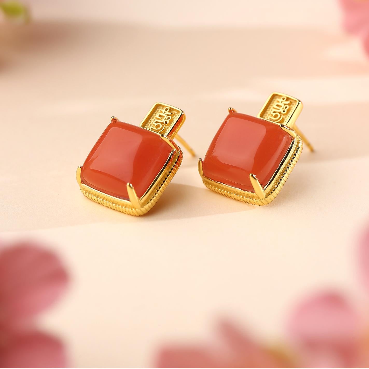 Tibetan Buddhist red agate earrings representing blessings, wealth, and serenity.