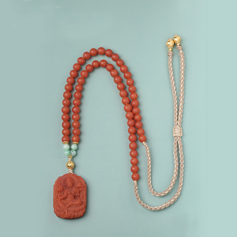 Tibetan red agate and jade amulet necklace inspired by Tara, symbolizing protection and harmony.