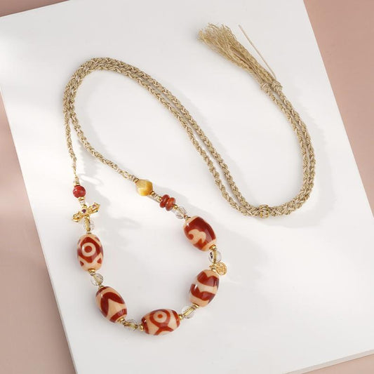 Handmade Tibetan Buddhist red agate and tiger eye pendant with 925 silver and cinnabar for spiritual protection.