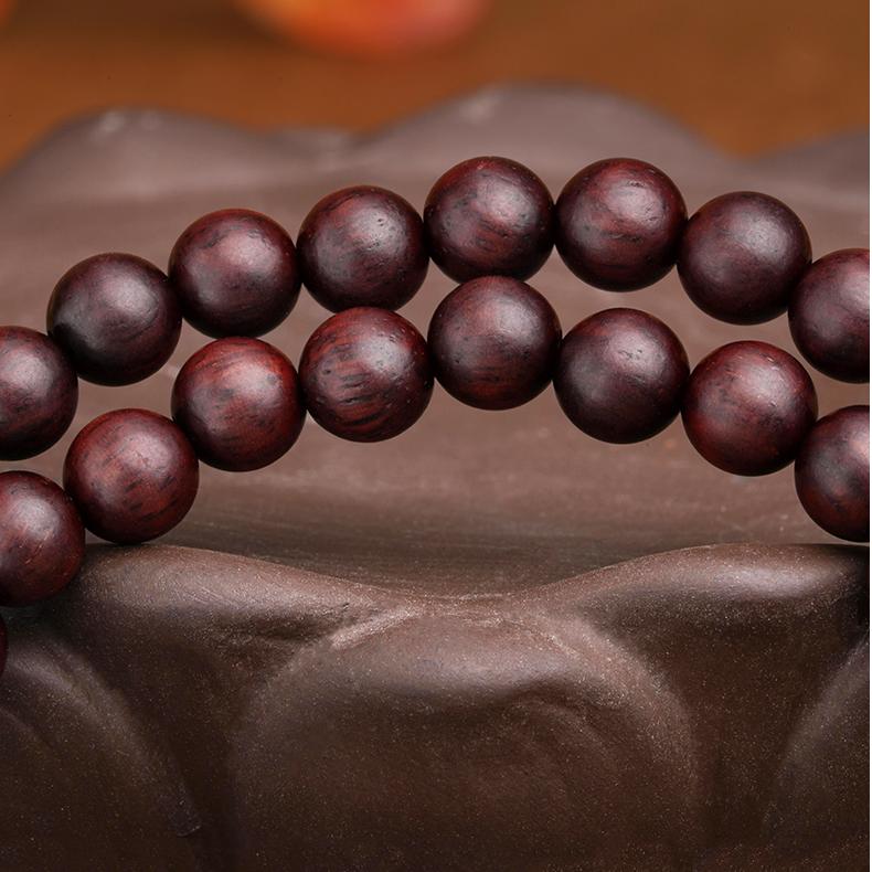 Handcrafted sandalwood and green phantom bracelet with elastic 15cm fit and detailed silver ornament.