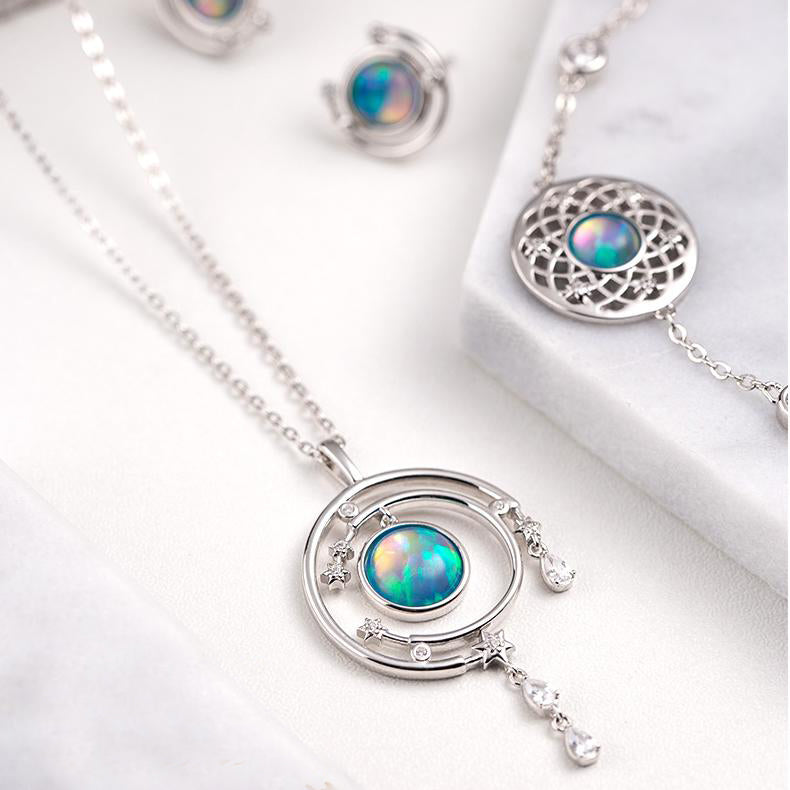 Buddha-inspired handmade jewelry with enamel opal design symbolizing compassion and balance.