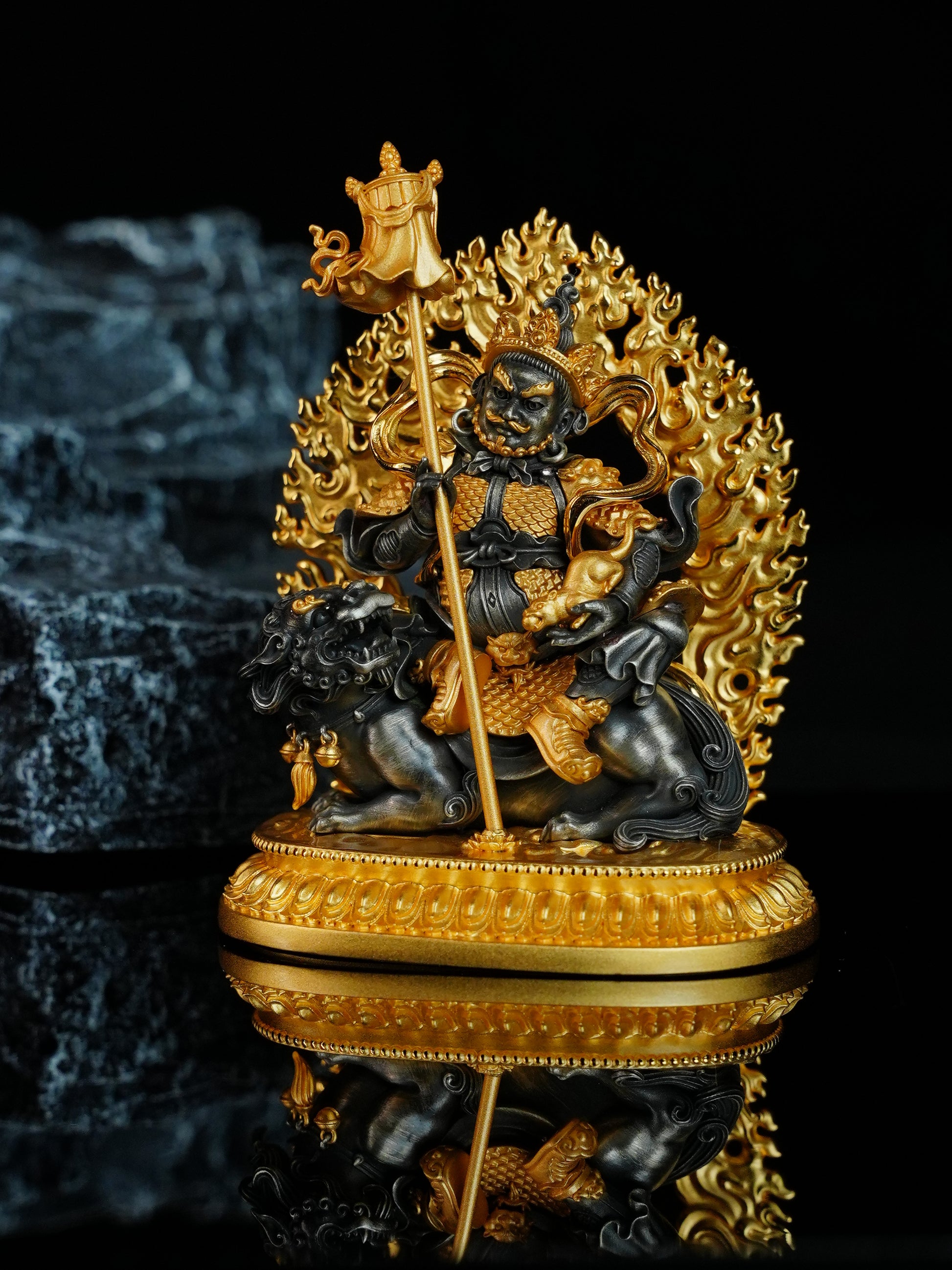Exquisite Buddhist sacrificial items art featuring a hand-carved gold Jambhala holding a treasure-spitting mongoose on a snow lion.

