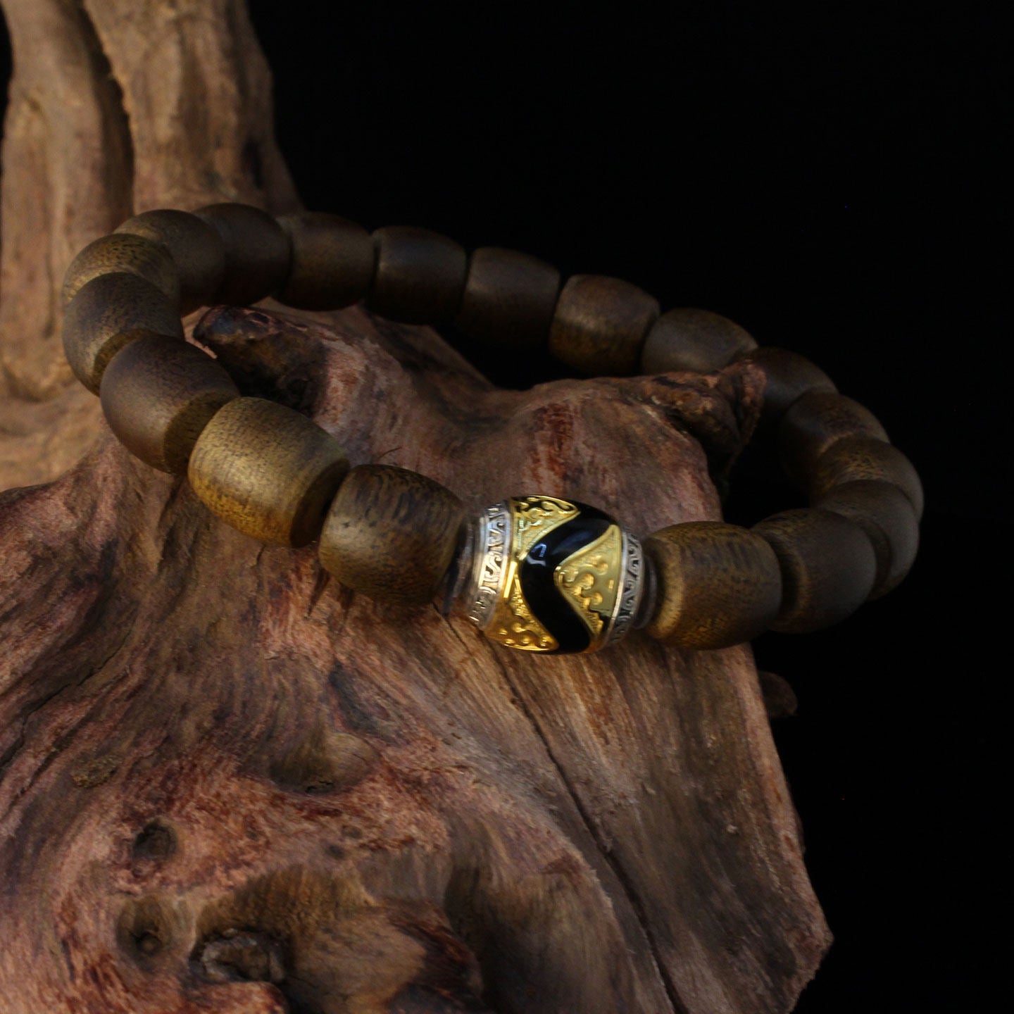 Close-up of Buddhist sacrificial items art featuring high-quality scented agarwood beads and a hand-carved tiger tooth Dzi.
