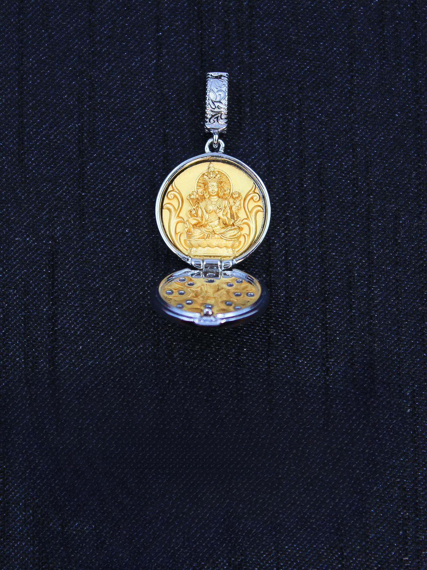 Exquisite Buddhist sacrificial items art featuring a hand-carved Green Tara sitting inside an openable gold-gilded silver shrine.