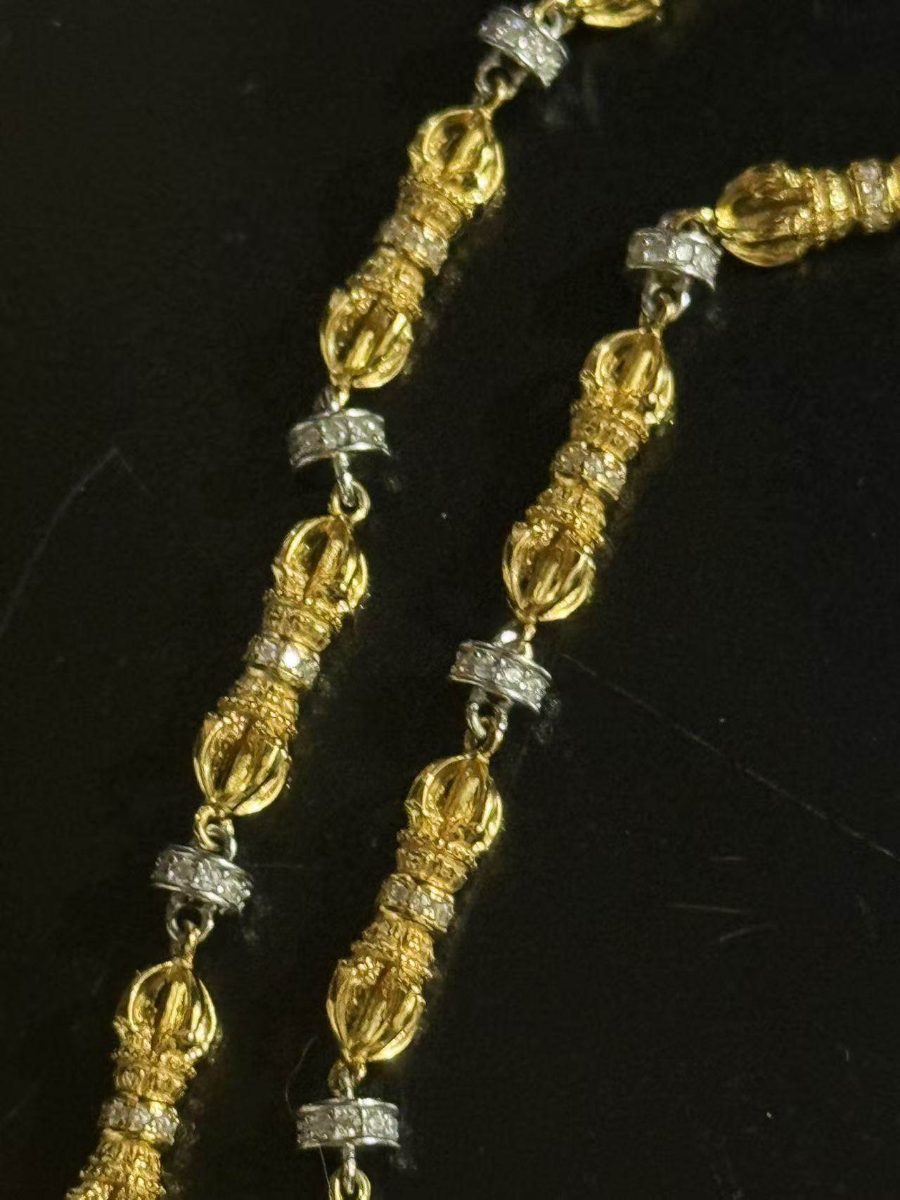 A wearer displaying the sacred Dorje pendant necklace for dispelling negative energy, representing Buddhist sacrificial items art.