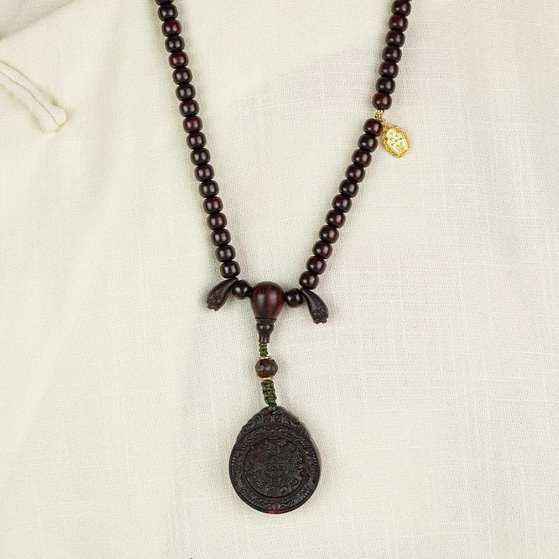 Tibetan handmade rosewood Bagua pendant necklace symbolizing strength, peace, and spiritual awakening.