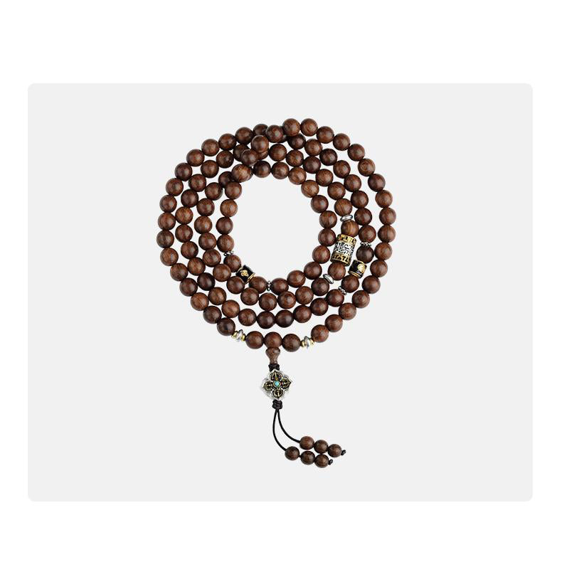 Tibetan Buddhist golden sandalwood 108 mala featuring copper lucky bead accents and natural wood grains.