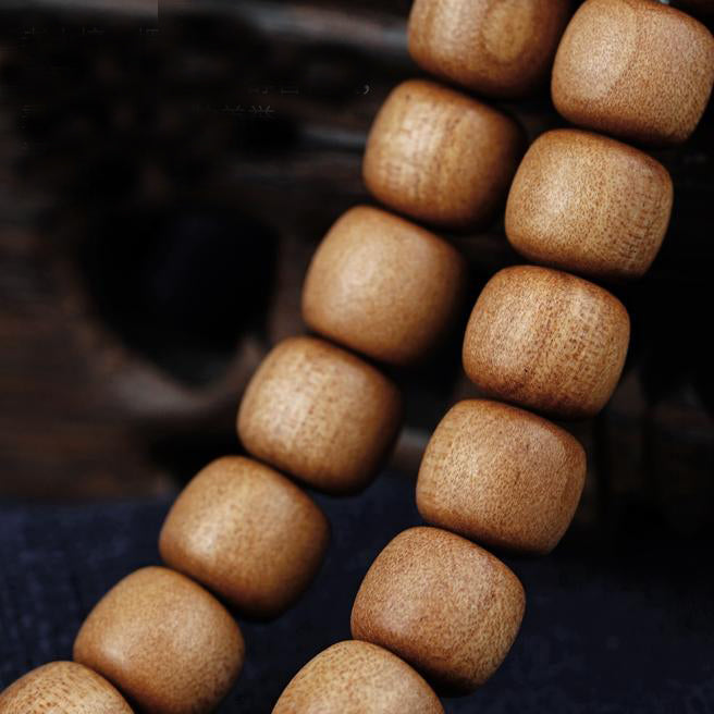 Handmade Tibetan sandalwood and amber necklace symbolizing spiritual growth, compassion, and serenity.