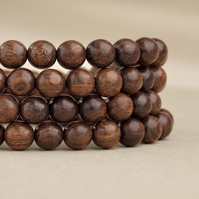 Traditional Tibetan Buddhist 108 mala handcrafted from golden sandalwood and copper details.