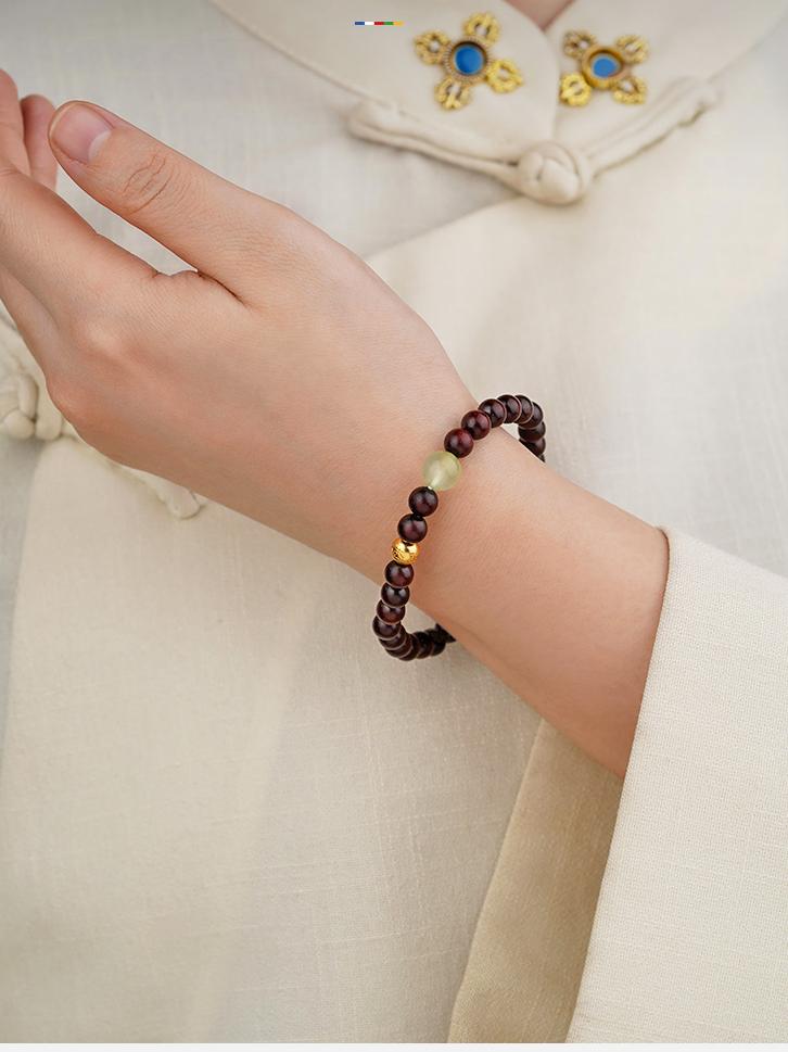 Close-up of Tibetan-Buddhist bracelet with 6mm sandalwood beads and 8mm prehnite stones