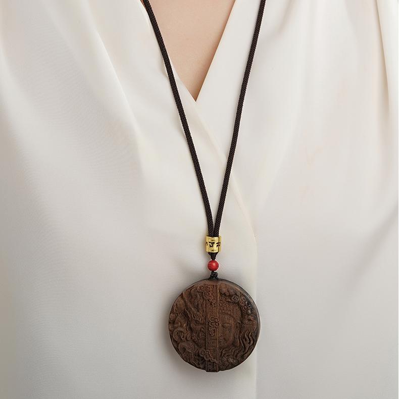Handmade Tibetan Buddhist agarwood sandalwood jewelry with vermilion bead, symbolizing mindfulness.