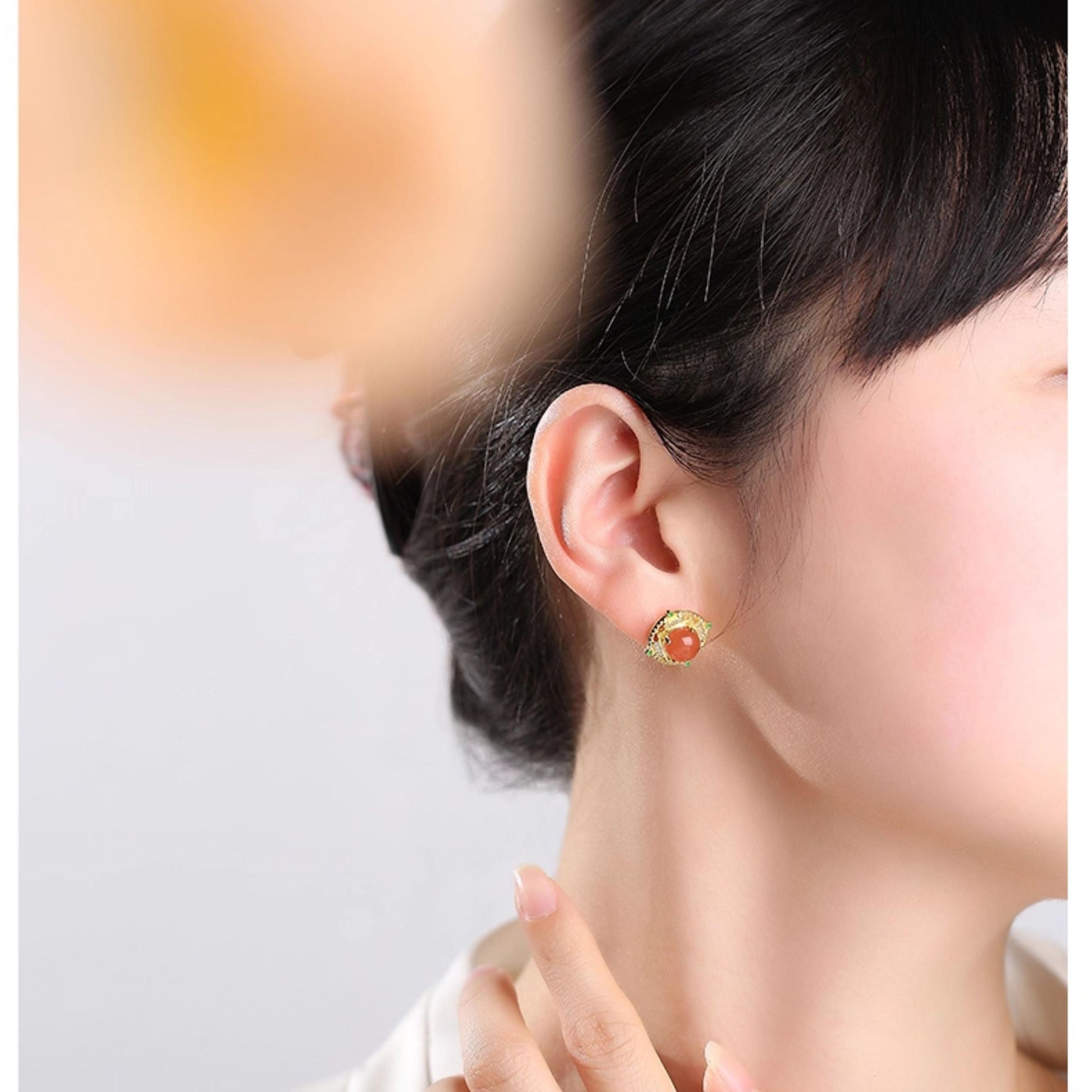 "Handcrafted South Red Coral ear studs in 925 silver, inspired by Tibetan Buddhist teachings of happiness, spiritual bliss, and longevity."