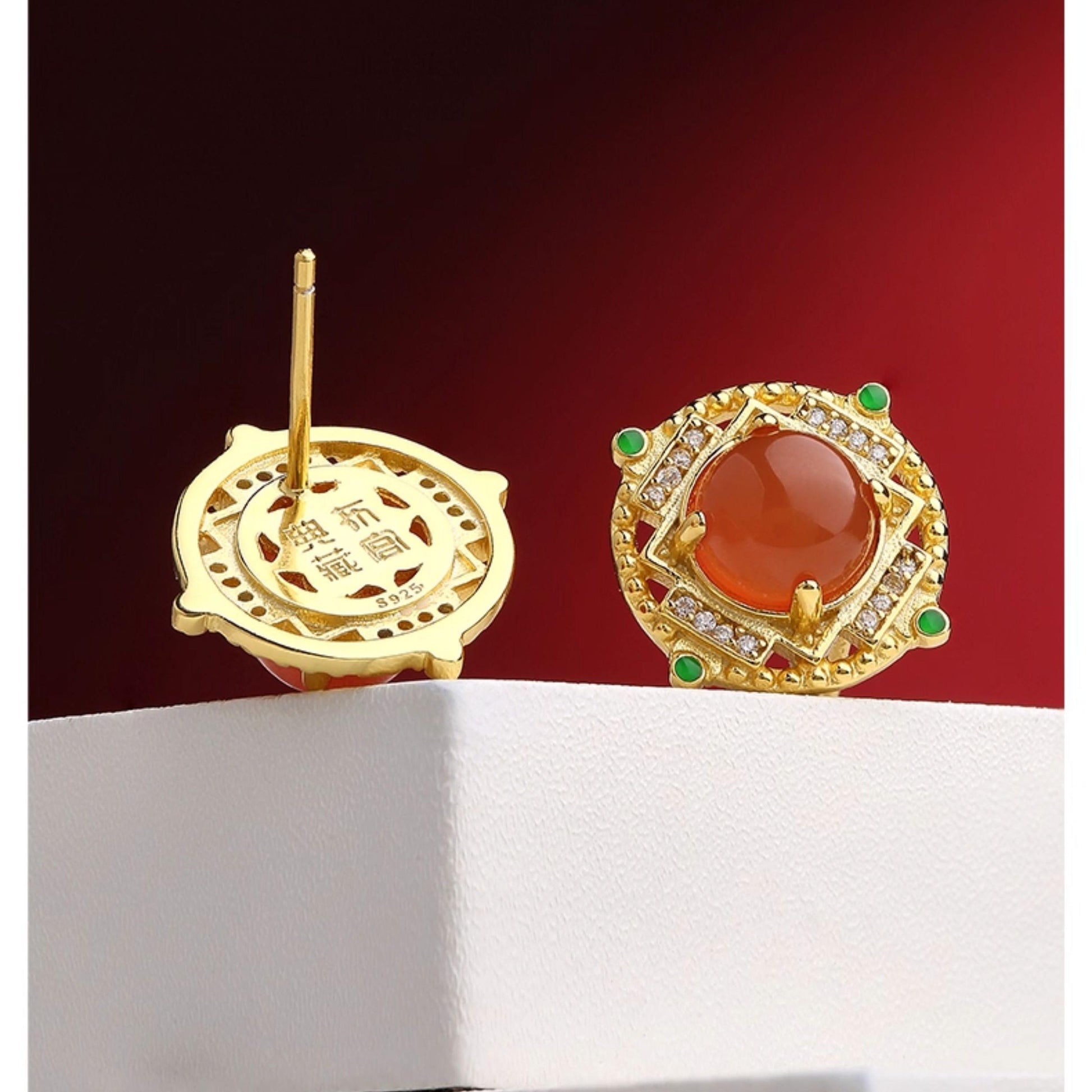 "Tibetan Buddhist Sheng Le Chang Huan ear studs with South Red Coral, representing spiritual harmony, bliss, and prosperity."