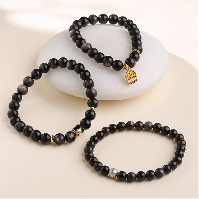 Tibetan-Buddhist handcrafted obsidian bracelet with Potala-inspired aesthetic and copper bead accents.