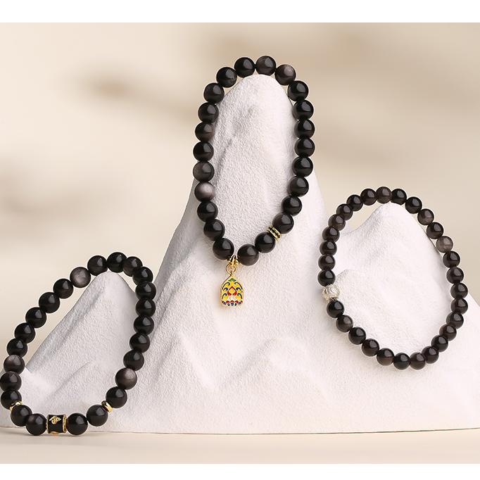 Tibetan-Buddhist silver obsidian bracelet Xinghai model with copper charm artistry and fine bead detailing.