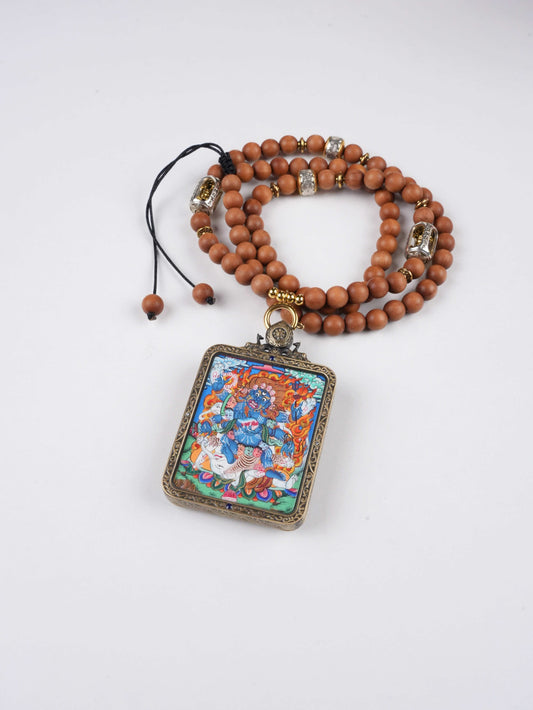 Mini Tibetan Thangka pendant of Six-Armed Mahakala, crafted on sacred Thangka canvas with mineral pigments.