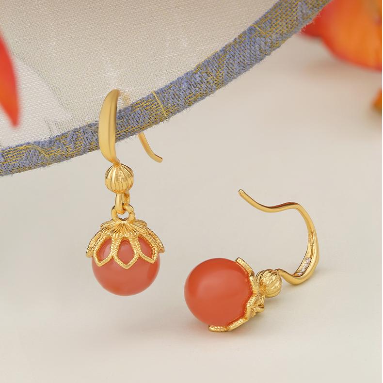 "Tibetan Buddhist-inspired ear pendants with South Red Coral and 925 silver, symbolizing enlightenment and clarity."