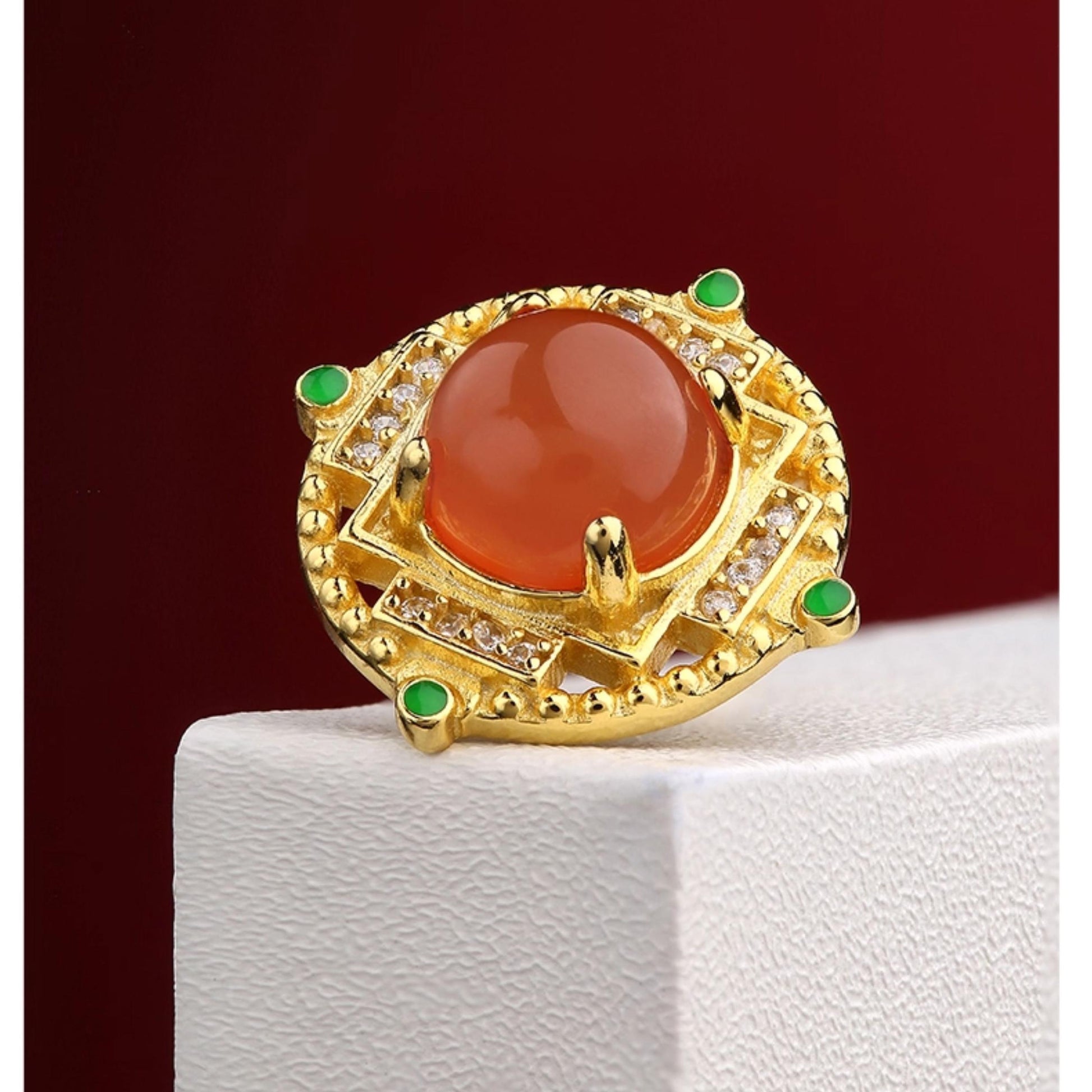 "Handmade South Red Coral ear studs in 925 silver, symbolizing the continuous flow of joy and good fortune in Tibetan Buddhism."