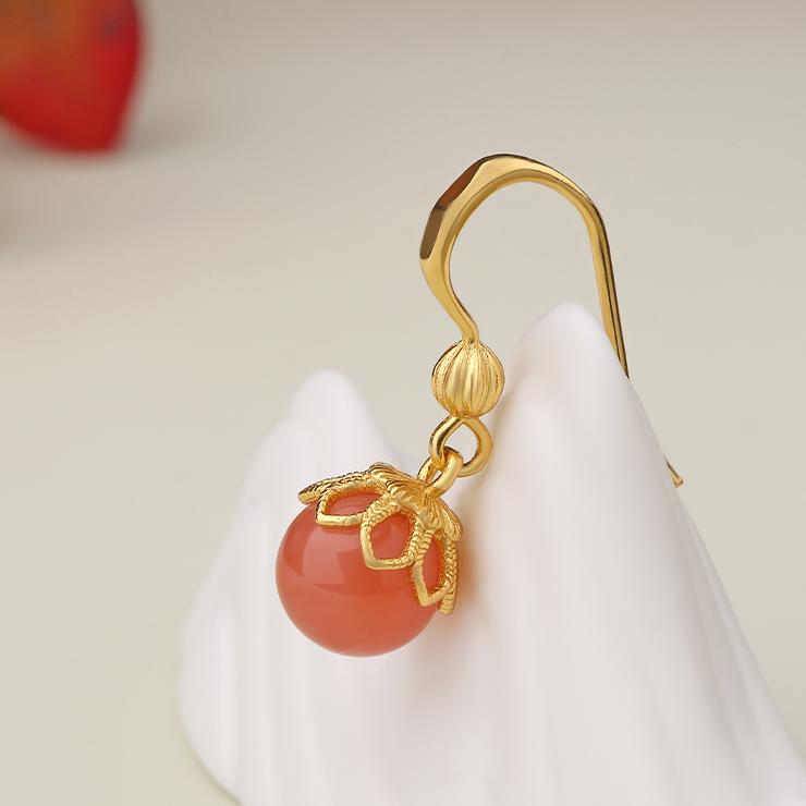 "Elegant South Red Coral ear pendants in 925 silver, handcrafted to embody Tibetan Buddhist themes of purity and serenity."