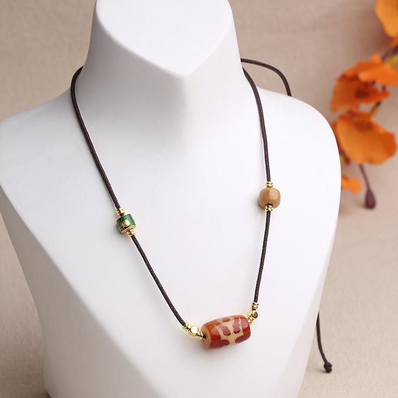 Spiritual amulet necklace featuring a Nobleman Dzi symbol for protection and auspicious connections.