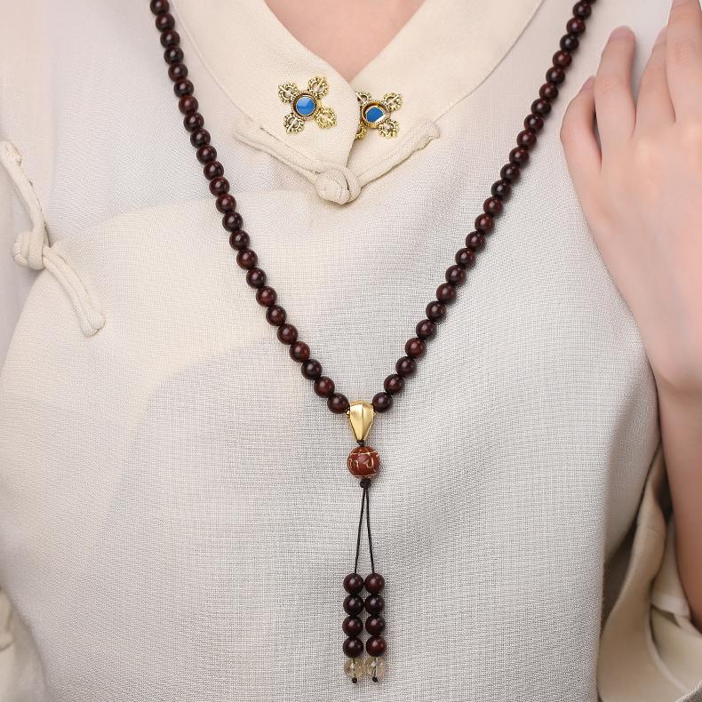 Tibetan Buddhist spiritual mala necklace crafted from sandalwood golden rutile and silver mantra bead