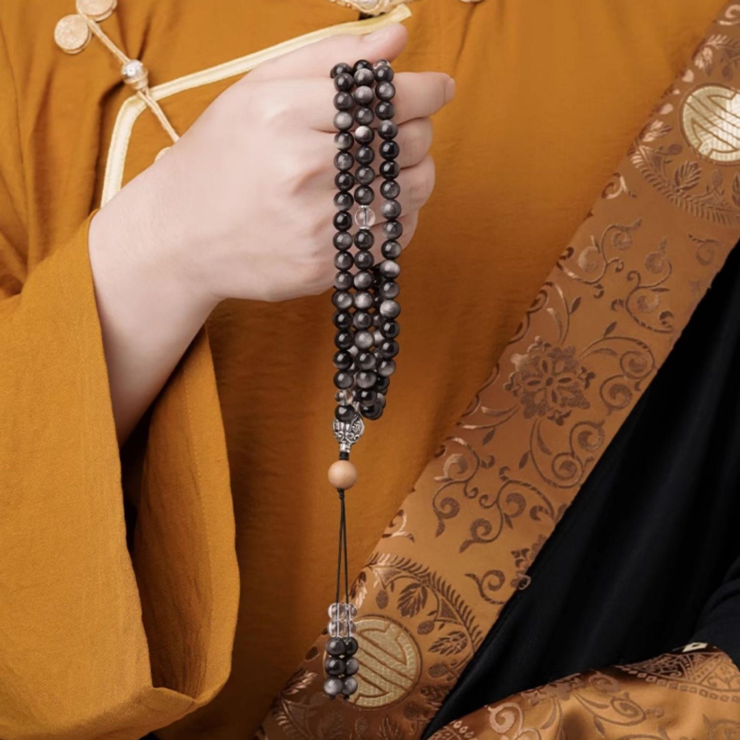 Tibetan Buddhist spiritual mala necklace crafted from silver obsidian sandalwood and clear crystal