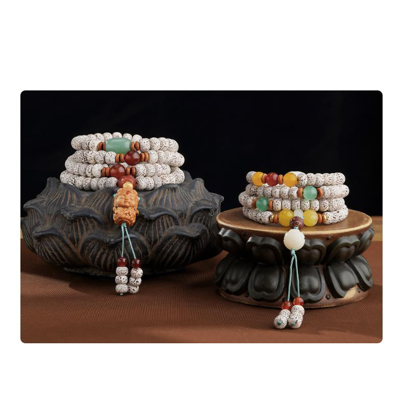 Tibetan Buddhist carved Bodhi pendant mala featuring multi-gemstone elements and spiritual craftsmanship.