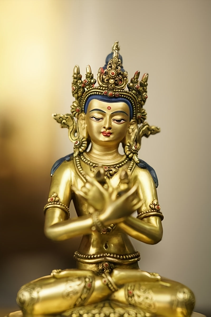 Vajradhara Buddhist statue in meditative posture, made of finely crafted gilded brass. A prime example of handmade Tibetan Buddhist statues.