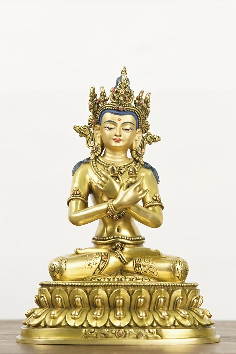 Serene Vajradhara figure, a central icon in Tibetan Buddhism. This gilded brass sculpture is a fine piece of collectible Buddhist art.