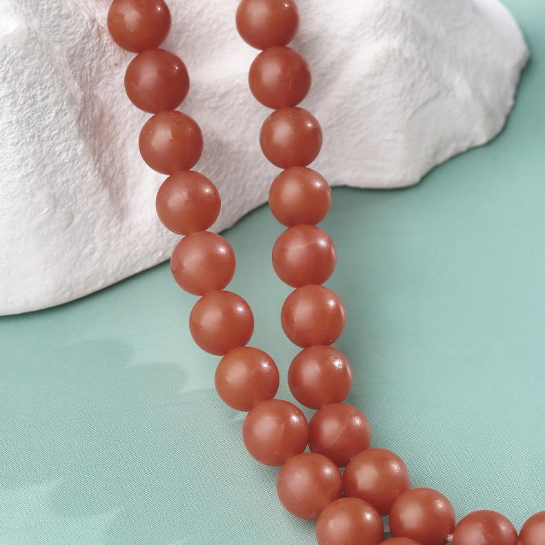 Handcrafted Tibetan Buddhist Tara necklace in red agate and jade, spiritual jewelry for inner balance.