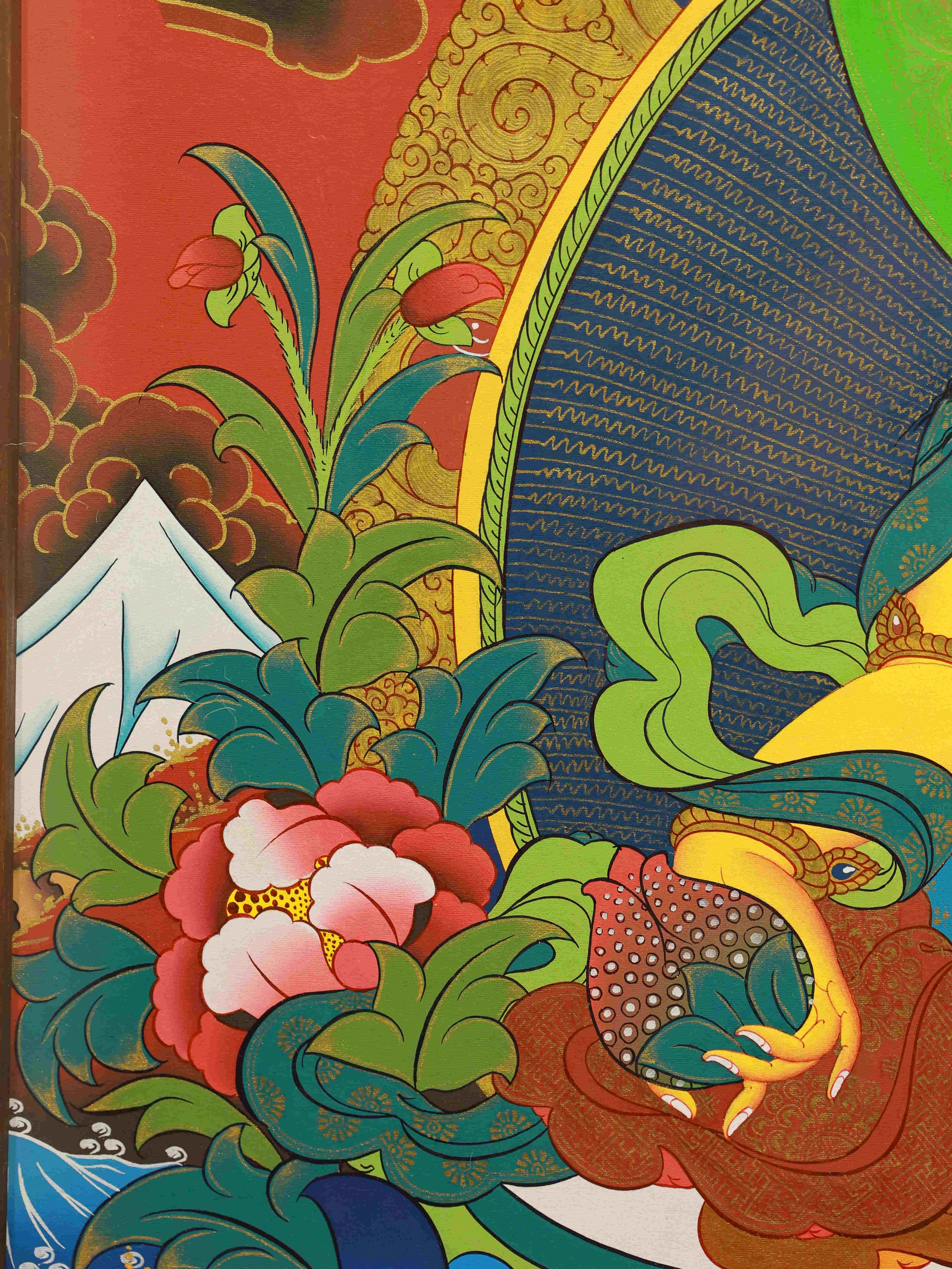 Traditional Tibetan Buddhist thangka painting depicting Yellow Jambhala, god of wealth.