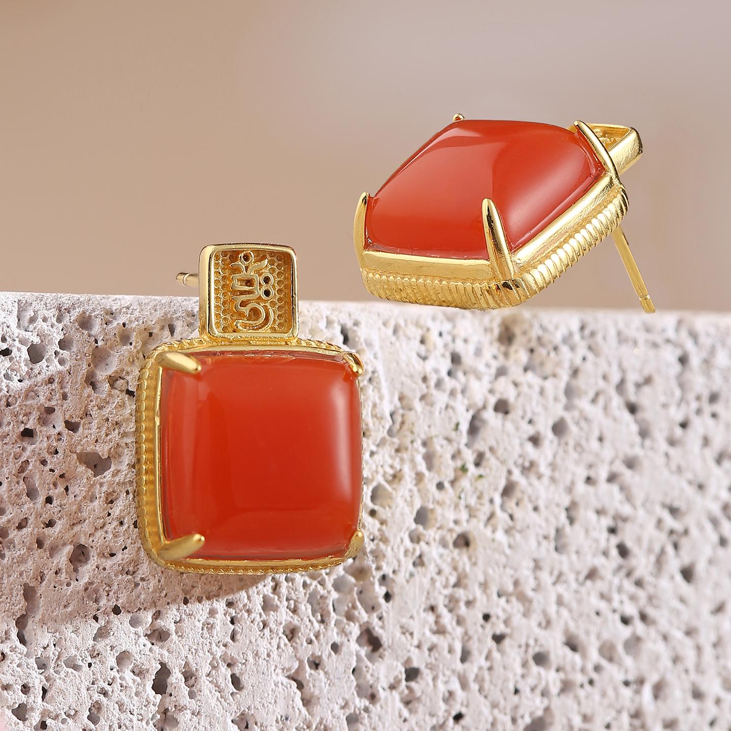 Tibetan Buddha art earrings made from red agate, gold, and silver — handcrafted for spiritual harmony.