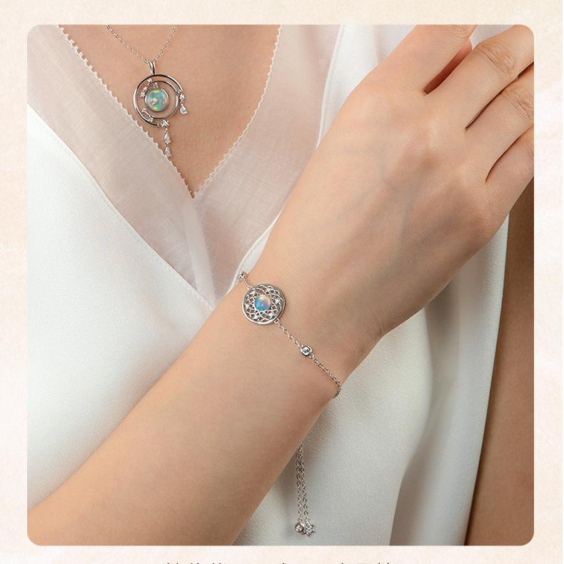 Moonlight opal earrings handcrafted in silver, reflecting Tibetan Buddhist harmony.