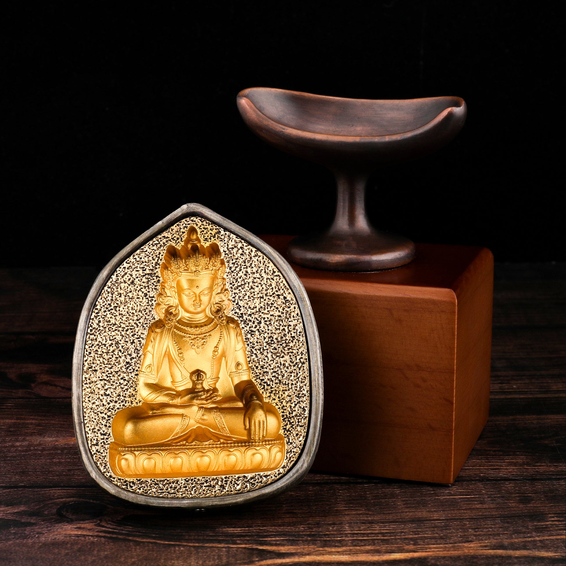 Tibetan tsatsa meditation ornament crafted with copper and wood elements.