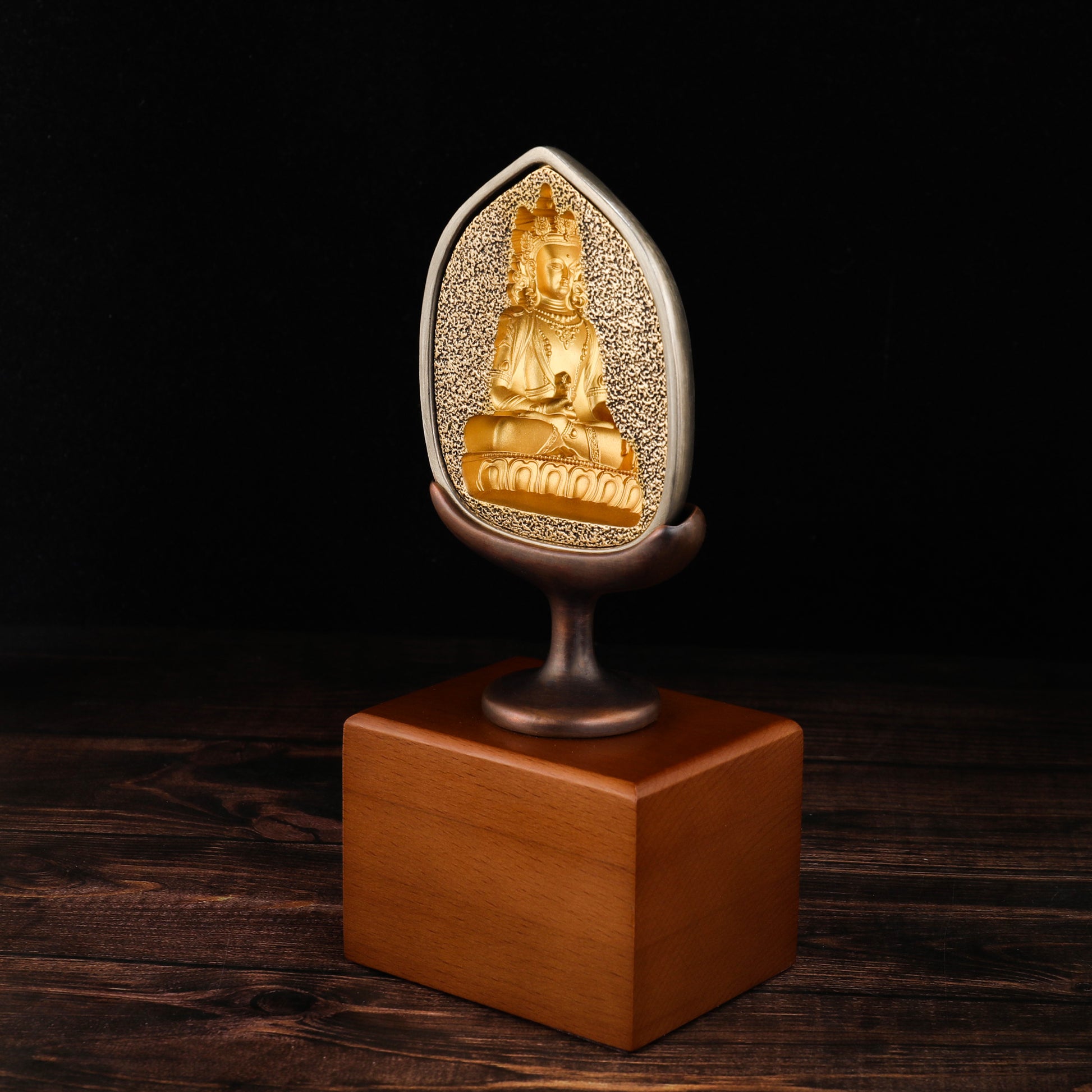 Tibetan tsatsa mold altar decoration crafted in brass and wood.