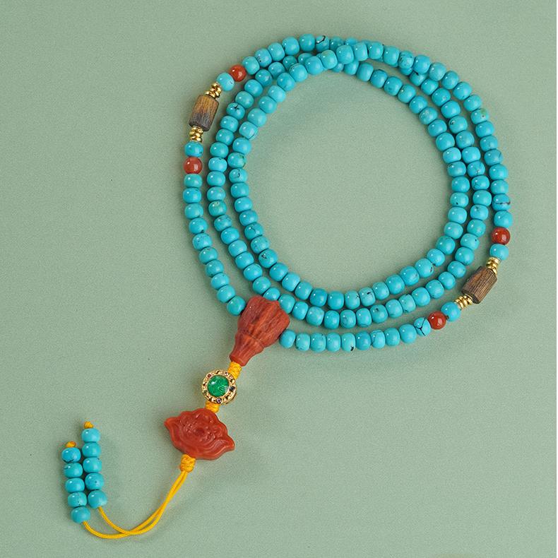 Handmade turquoise and red agate necklace with agarwood and silver, perfect for meditation and healing.