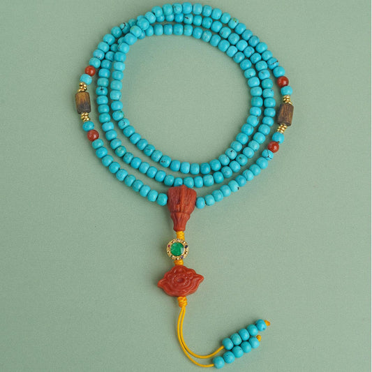 Handmade Tibetan Buddhist turquoise and south red agate necklace with agarwood and silver, symbolizing peace and strength.
