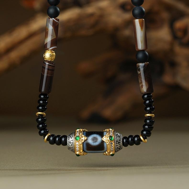Spiritual Tibetan jewelry piece with authentic Two-Eyed Dzi Bead and silver six-word mantra beads.