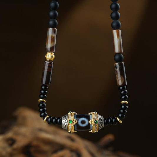 Handcrafted Tibetan Two-Eyed Dzi Bead Necklace made with agate, obsidian, coconut shell, and s925 silver.